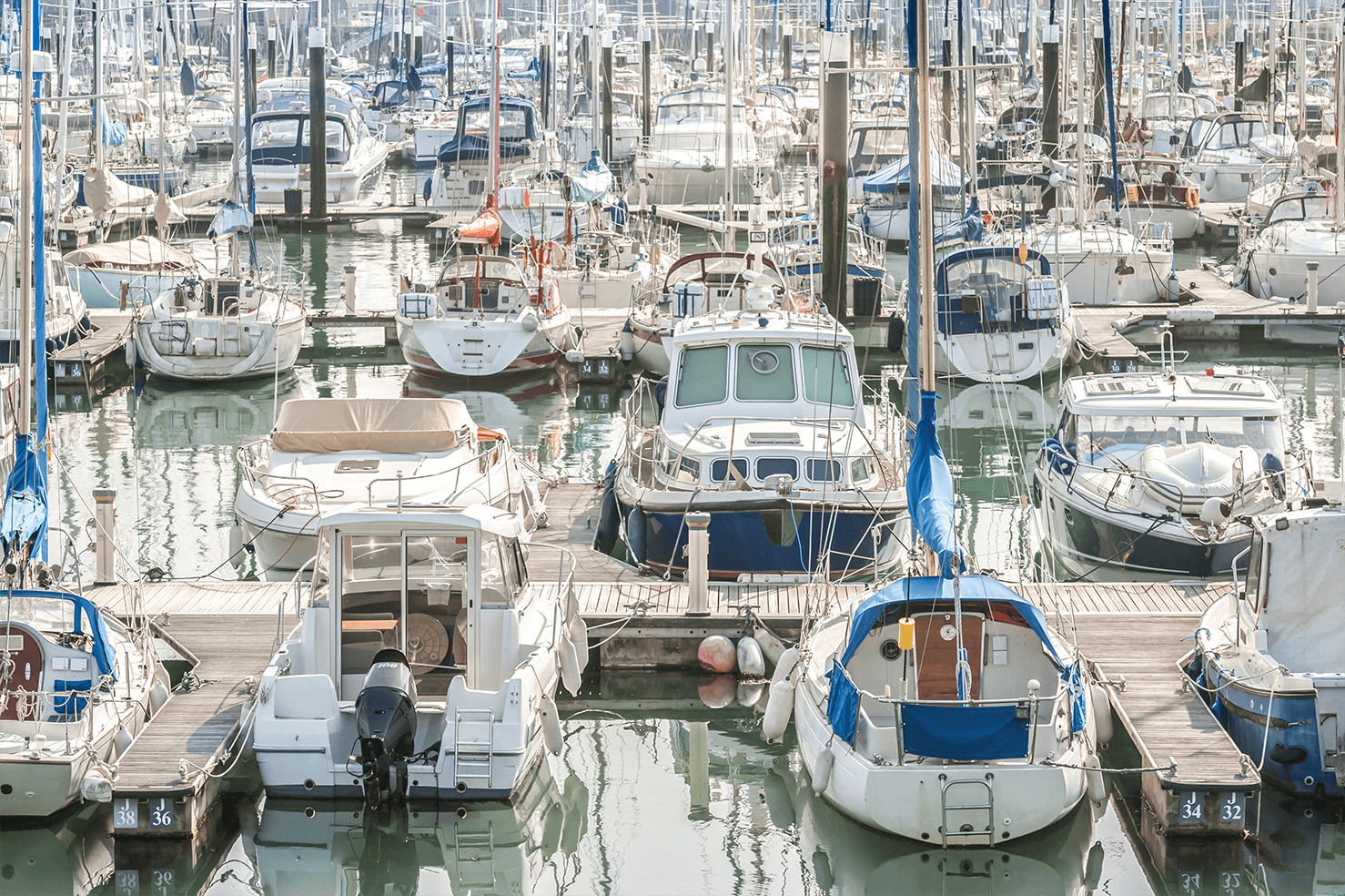 Diverse boats docked in a marina, ready for inspection with the 'Boat Owners Checklist' for safe and prepared sailing in the Channel Islands.